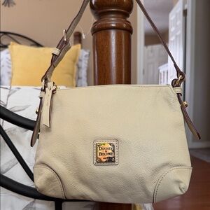 Dooney and Bourke bag in cream pebbled leather.